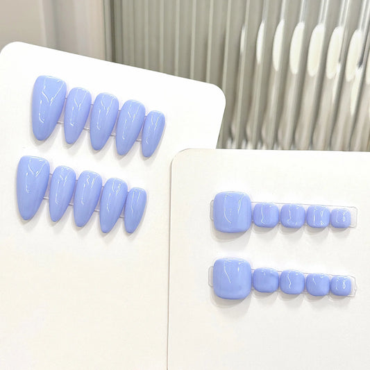 Set of light blue false teeth on a white background
