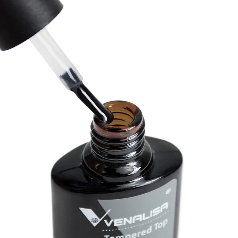Black nail polish bottle with a cap being applied, Venalisa brand visible