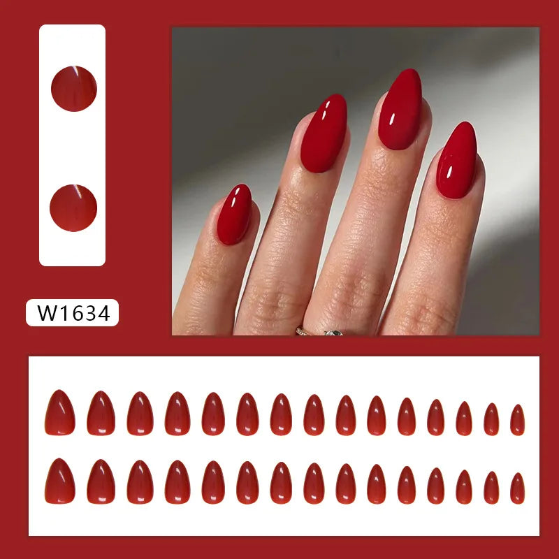 Red nail polish on nails with a matching nail decal set against a red border.