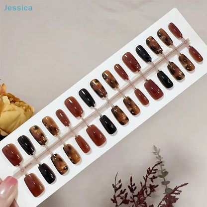 Set of brown and black nail samples on a display card with 'Jessica' branding.
