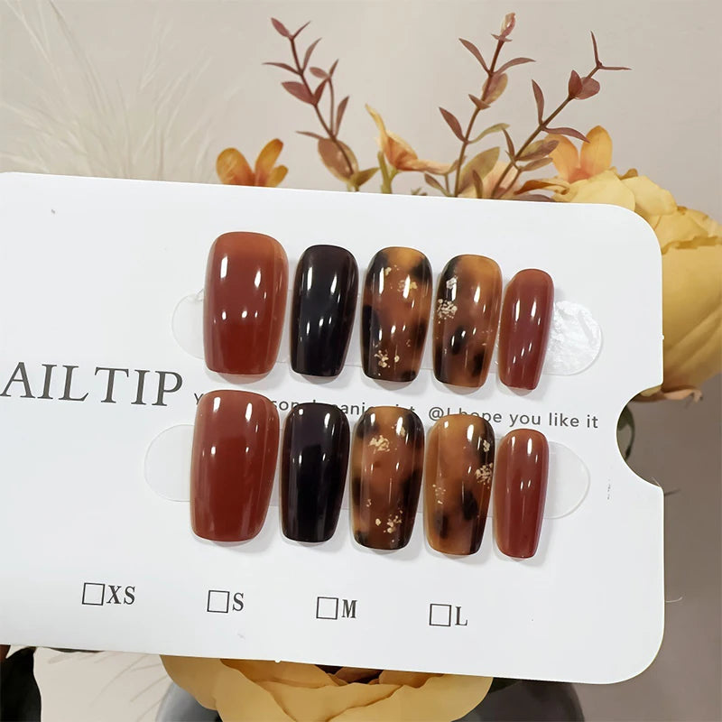 Set of brown and black nail tips on a white card with 'NAILTIP' branding.