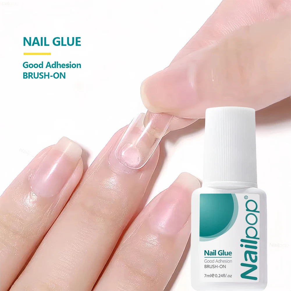 Nail Glue being applied to a finger with a bottle of Nailloop nail glue in the foreground.