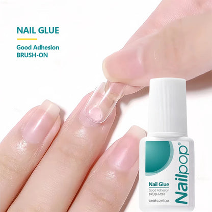 Nail Glue being applied to a finger with a bottle of Nailloop nail glue in the foreground.