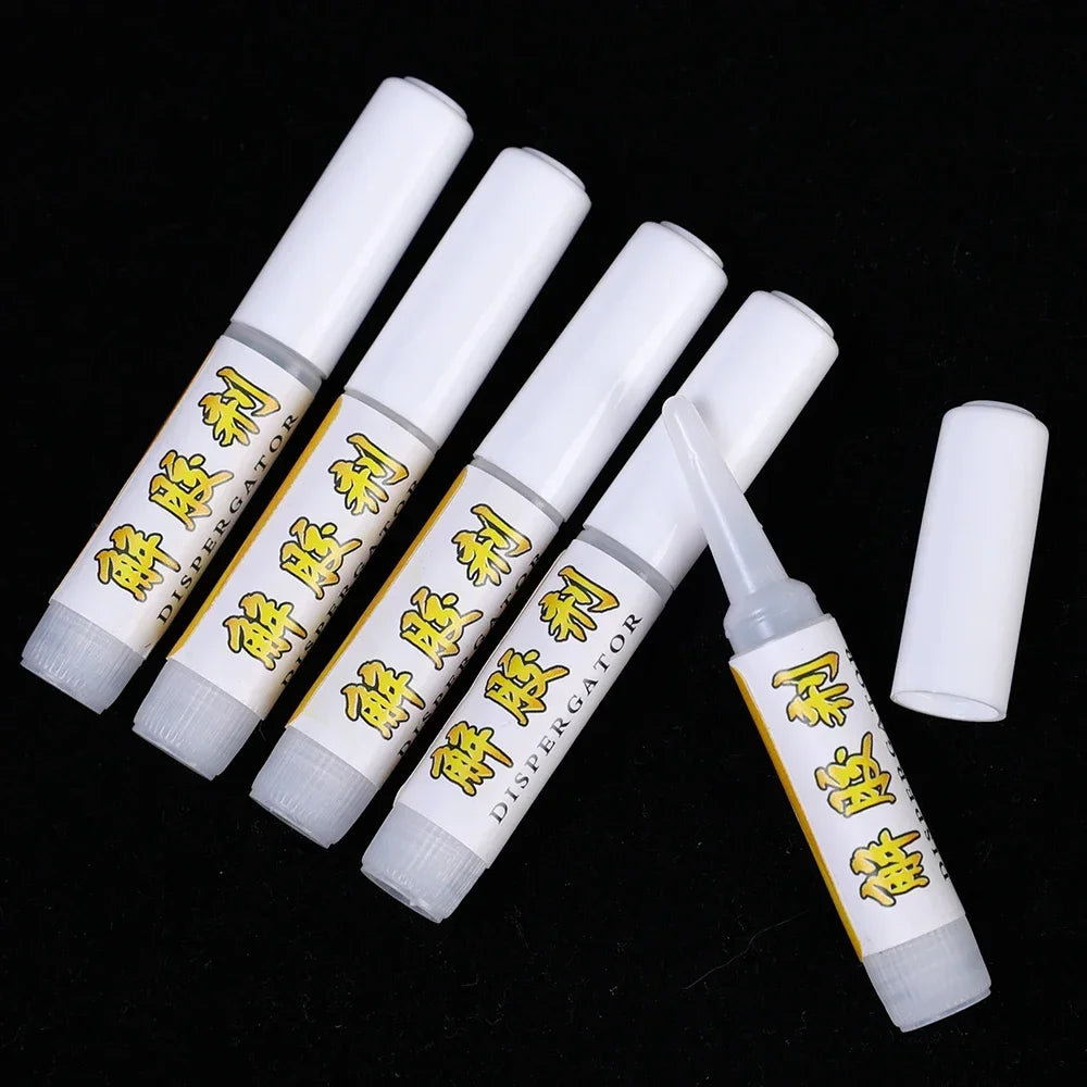 Set of white tubes with yellow text on a black background