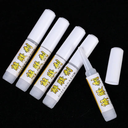 Set of white tubes with yellow text on a black background