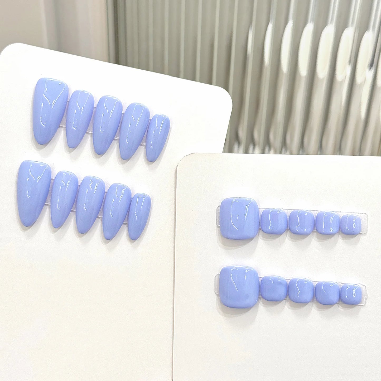Set of light blue false teeth on a white background