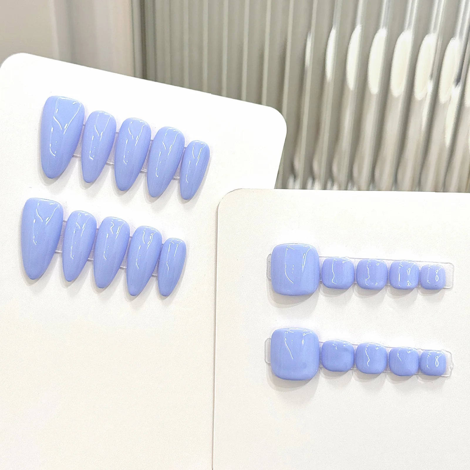 Set of light blue false teeth on a white background