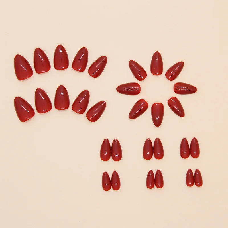 Red nail polish samples arranged in a circular pattern on a beige background