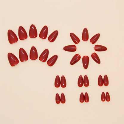 Red nail polish samples arranged in a circular pattern on a beige background