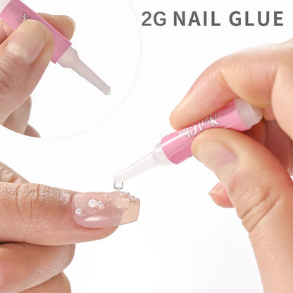 Person applying 2G nail glue to a nail with a pink applicator.