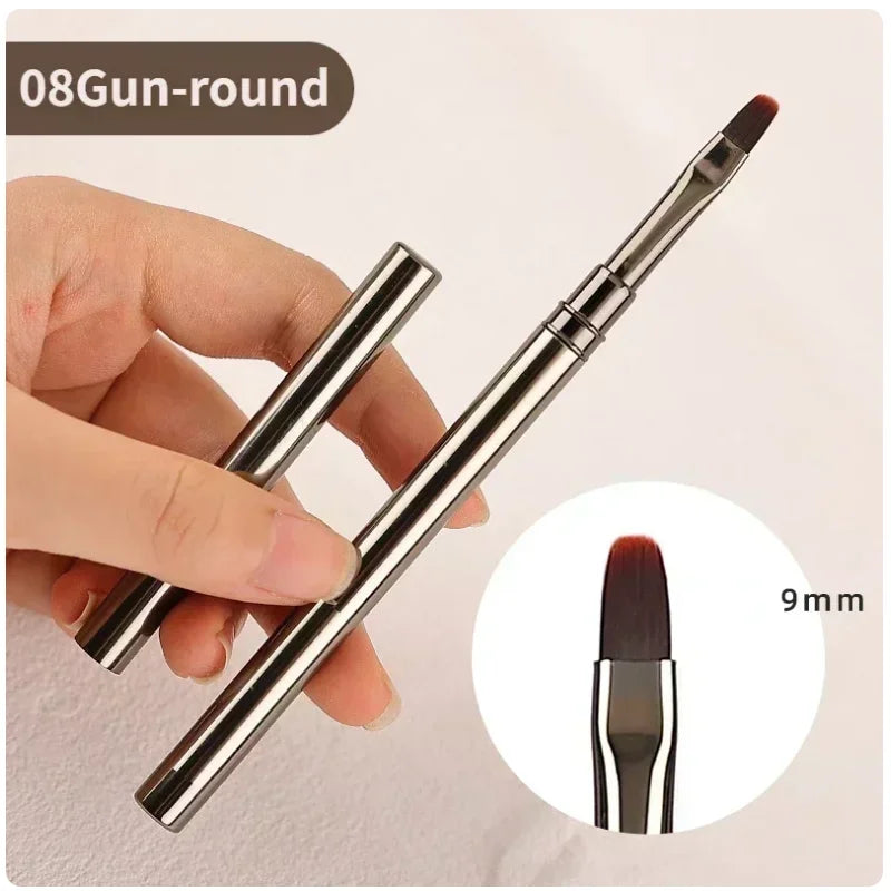 Metallic makeup brush held by a hand with close-up detail on bristle size.
