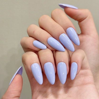 Hand with light purple nail polish on a neutral background
