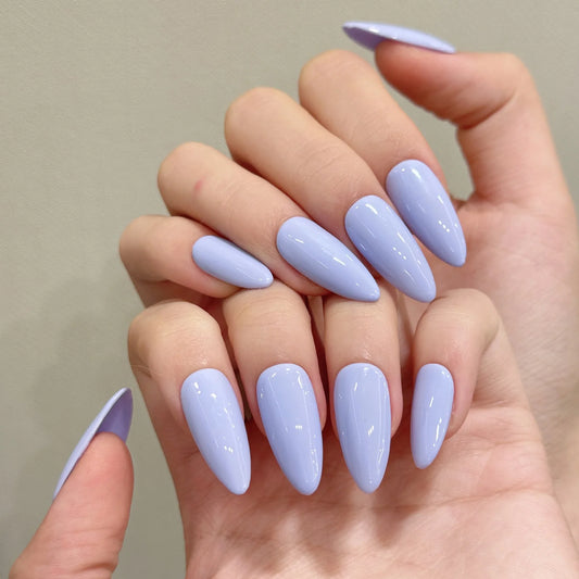 Hand with light purple nail polish on a neutral background