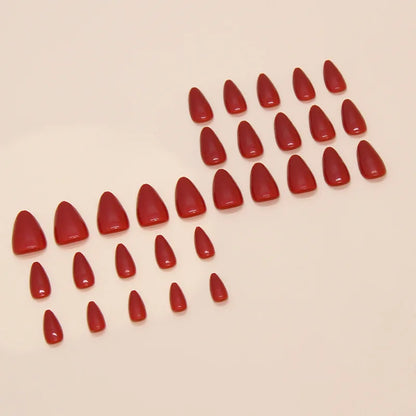 Set of red nail polish samples on a beige background