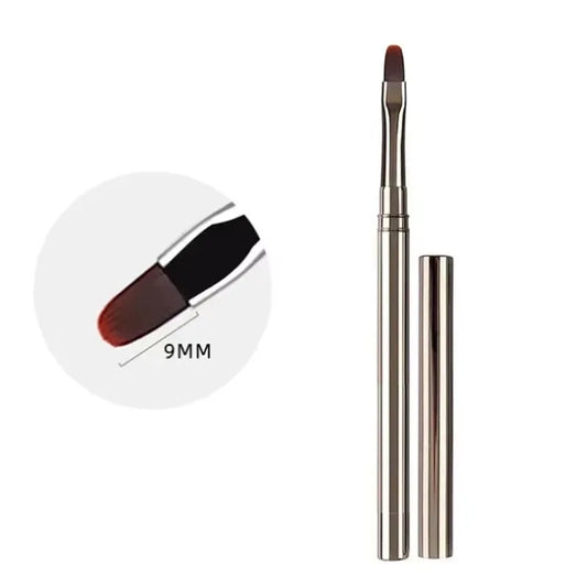 Makeup brush with a white handle and red bristle tip on a white background