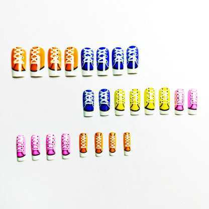 Colorful nail art designs resembling shoes on a white background