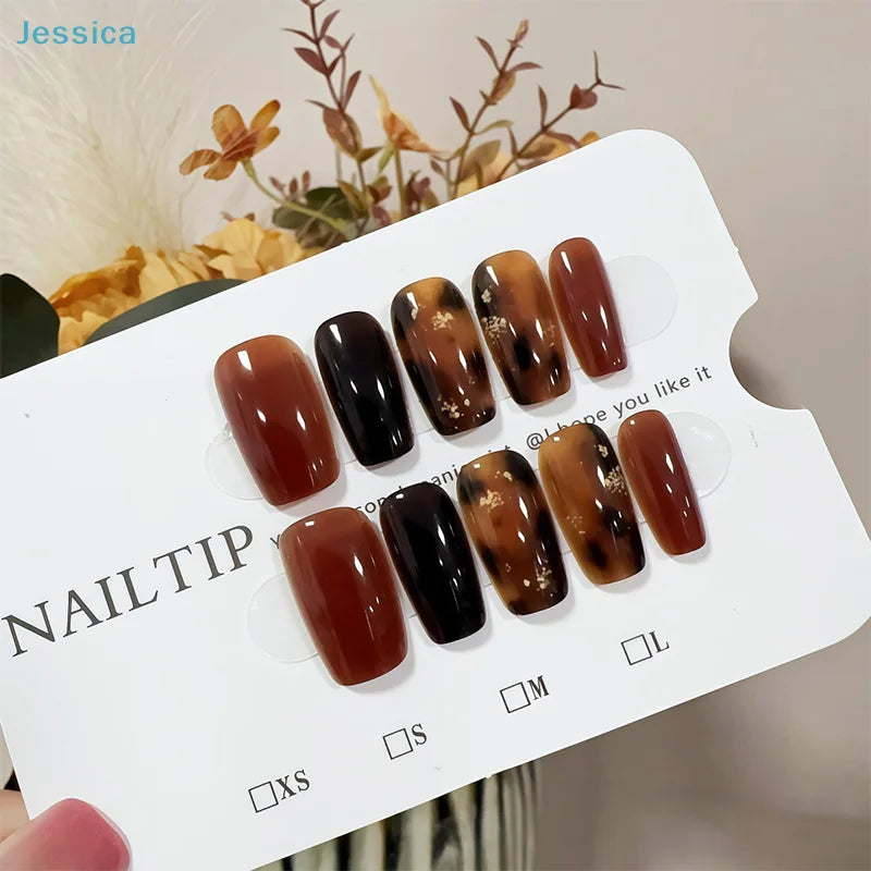 Set of brown and black nail tips on a display card with 'Jessica' branding.