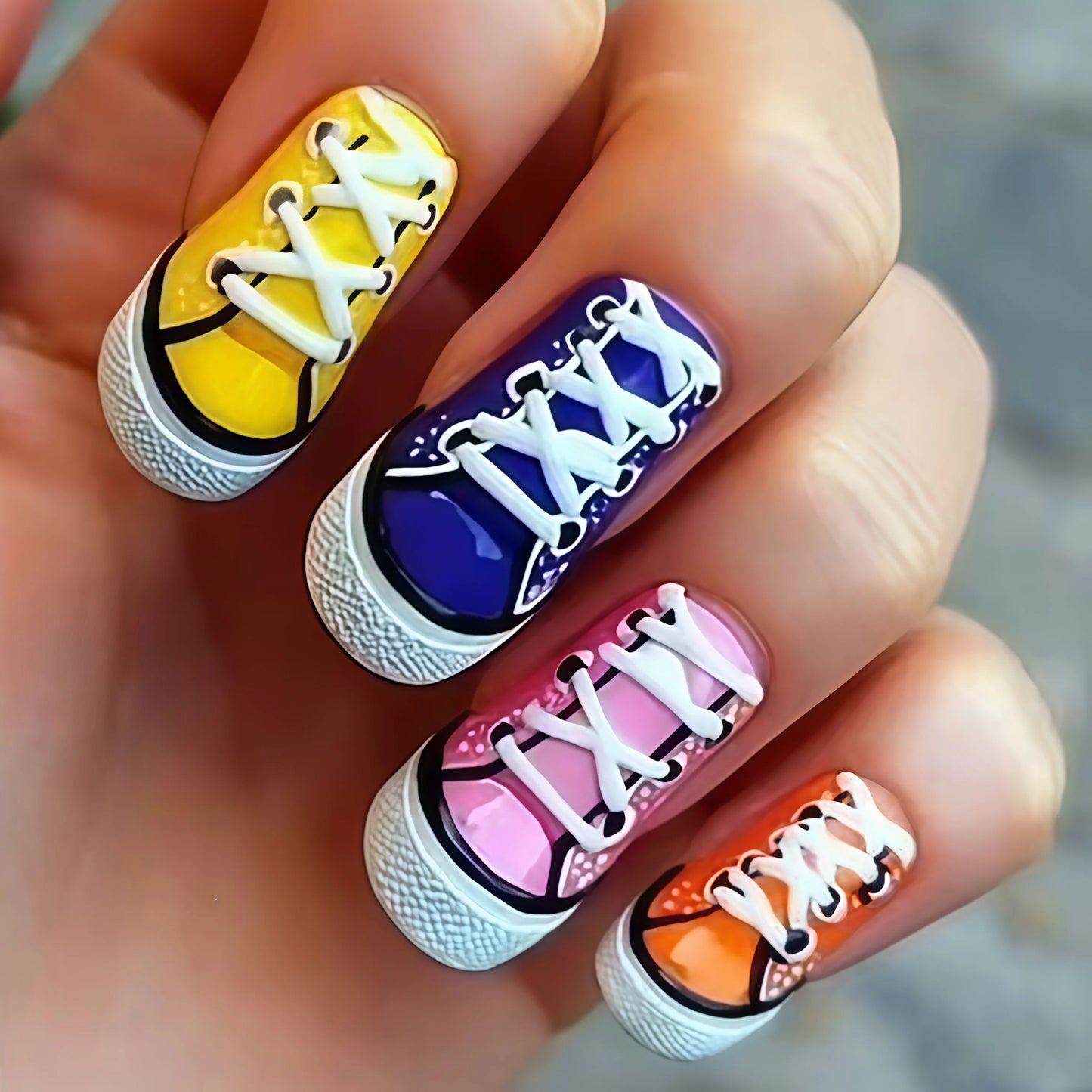 Nail art design resembling sneakers with colorful soles on a hand.
