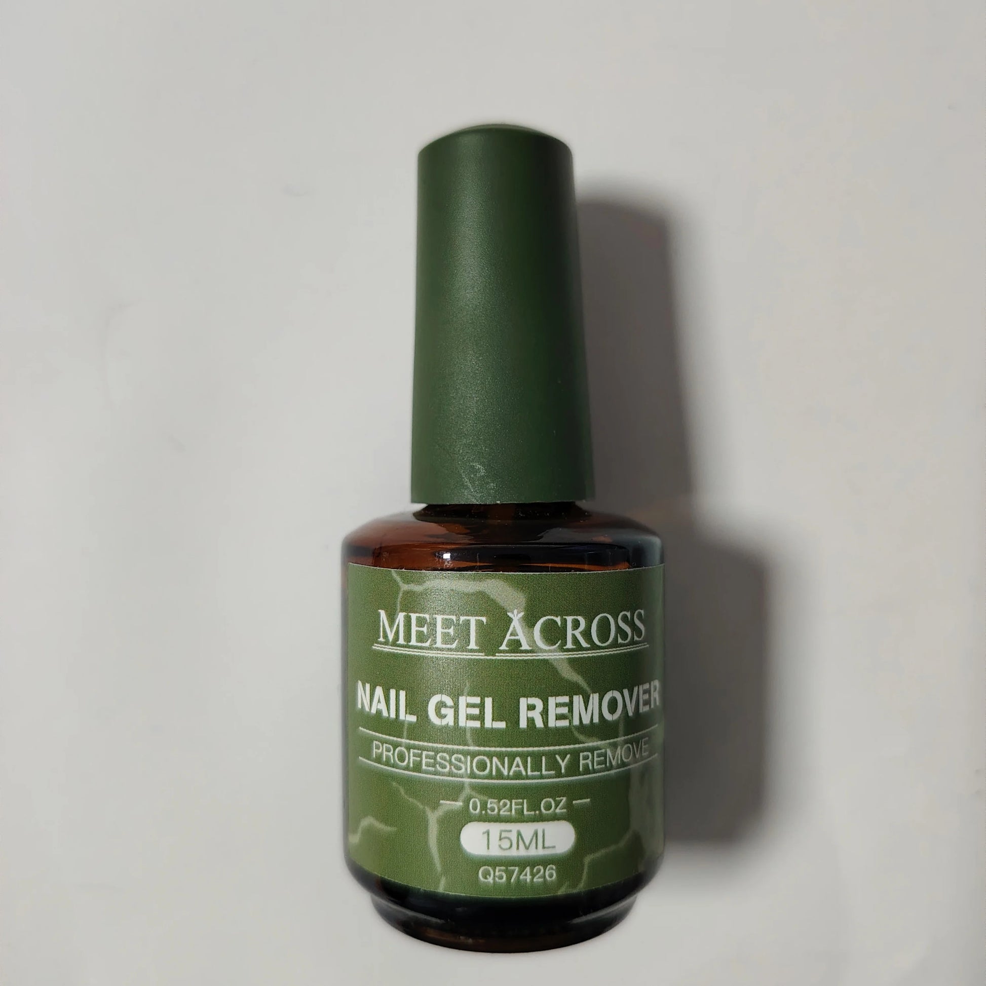 Bottle of Meet Across Nail Gel Remover on a light gray background