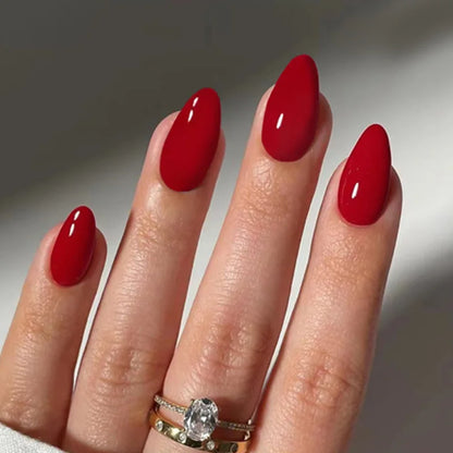 Hand with red nail polish on a neutral background