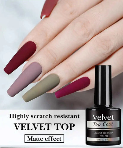 Hand with maroon, purple, and green nails next to a bottle of Velvet top coat.