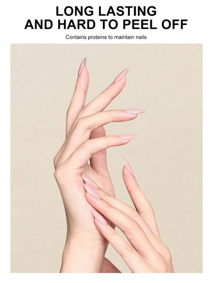 Close-up of hands with long, manicured nails on a beige background