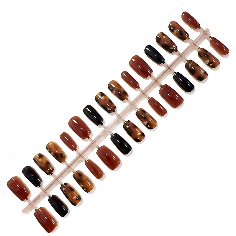 Set of brown and black nail polish samples on a white background