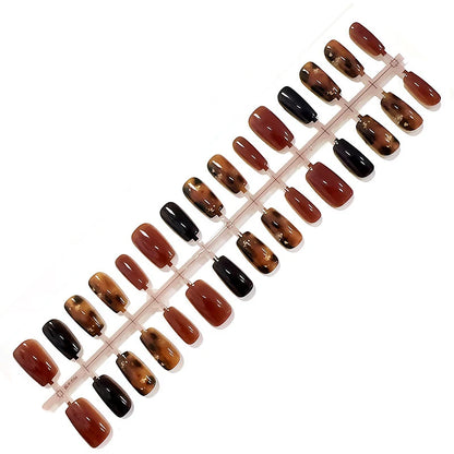 Set of brown and black nail polish samples on a white background