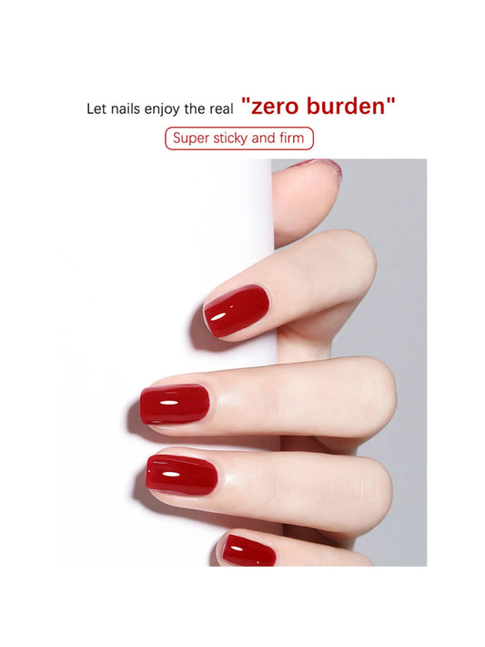 Hand with red nail polish on a white background, promoting 'zero burden' product.