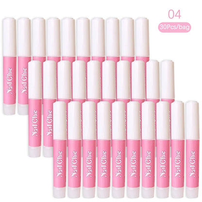 Multiple bottles of nail glue with pink caps and white bodies on a white background.