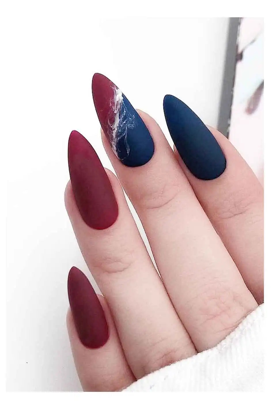 Nails with a design of red and blue colors on a white background